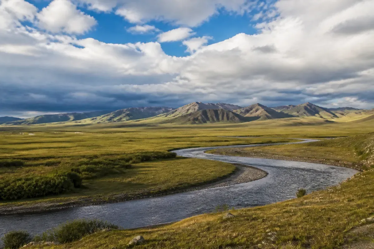 Steppe mongole, rivière et montagnes sous un ciel immense