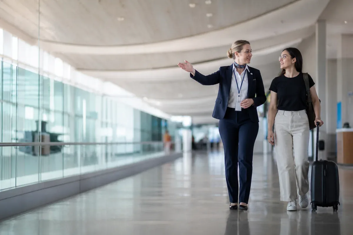 Professionnel de l’aérien accompagnant un voyageur dans un terminal